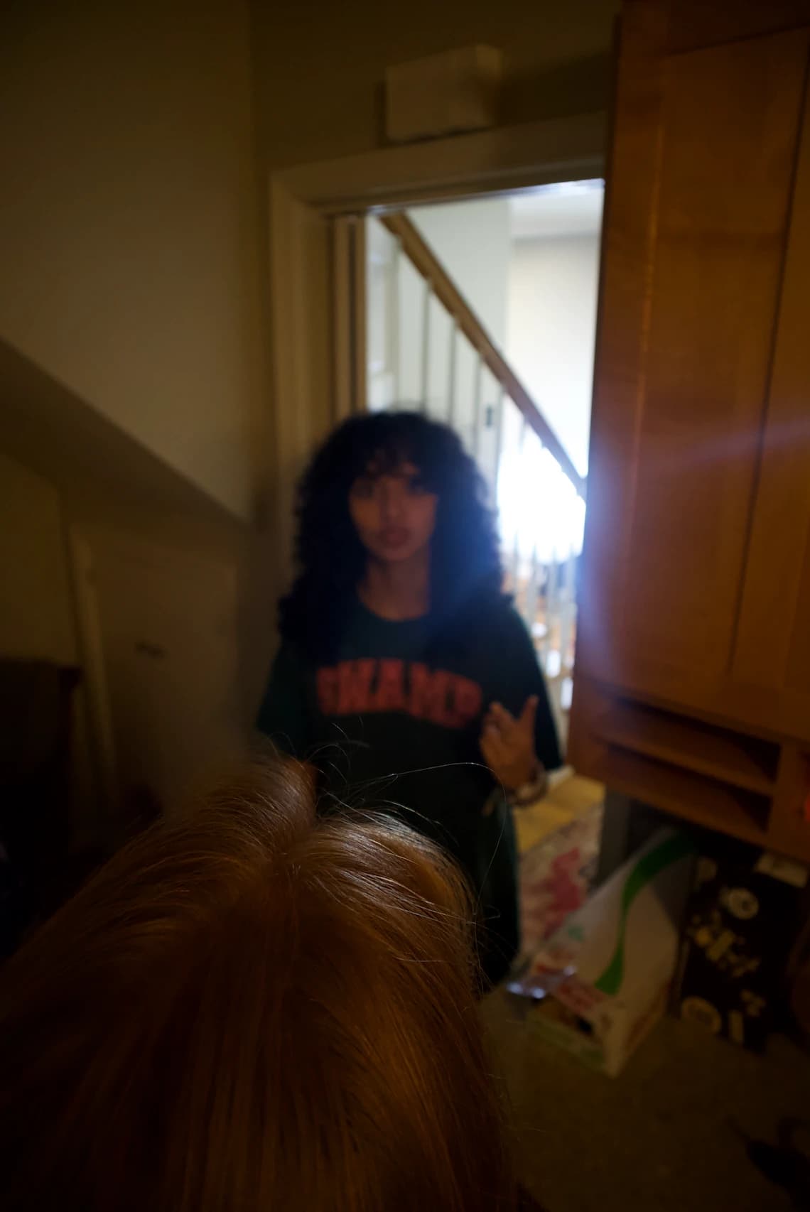 A model in a SWAMP shirt standing in a doorway